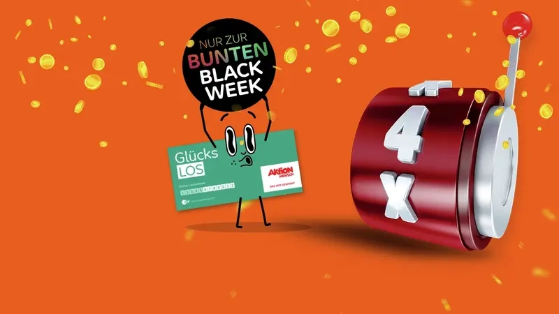 Auf einer orangenen Fläche sieht man, wie es goldene Münzen regnet. In der Mitte des Bildes steht eine Comicfigur, die aussieht, wie das Glücks-Los der Aktion Mensch. Es hat die Arme nach oben gestreckt und hält über dem Kopf einen schwarzen Kreis, auf dem in bunter Schrift geschrieben steht "Nur zur bunten Black Week". Rechts neben der Figur ist in rot in einarmiger Bandit zu sehen, auf dem der Text "4x" zu lesen ist.