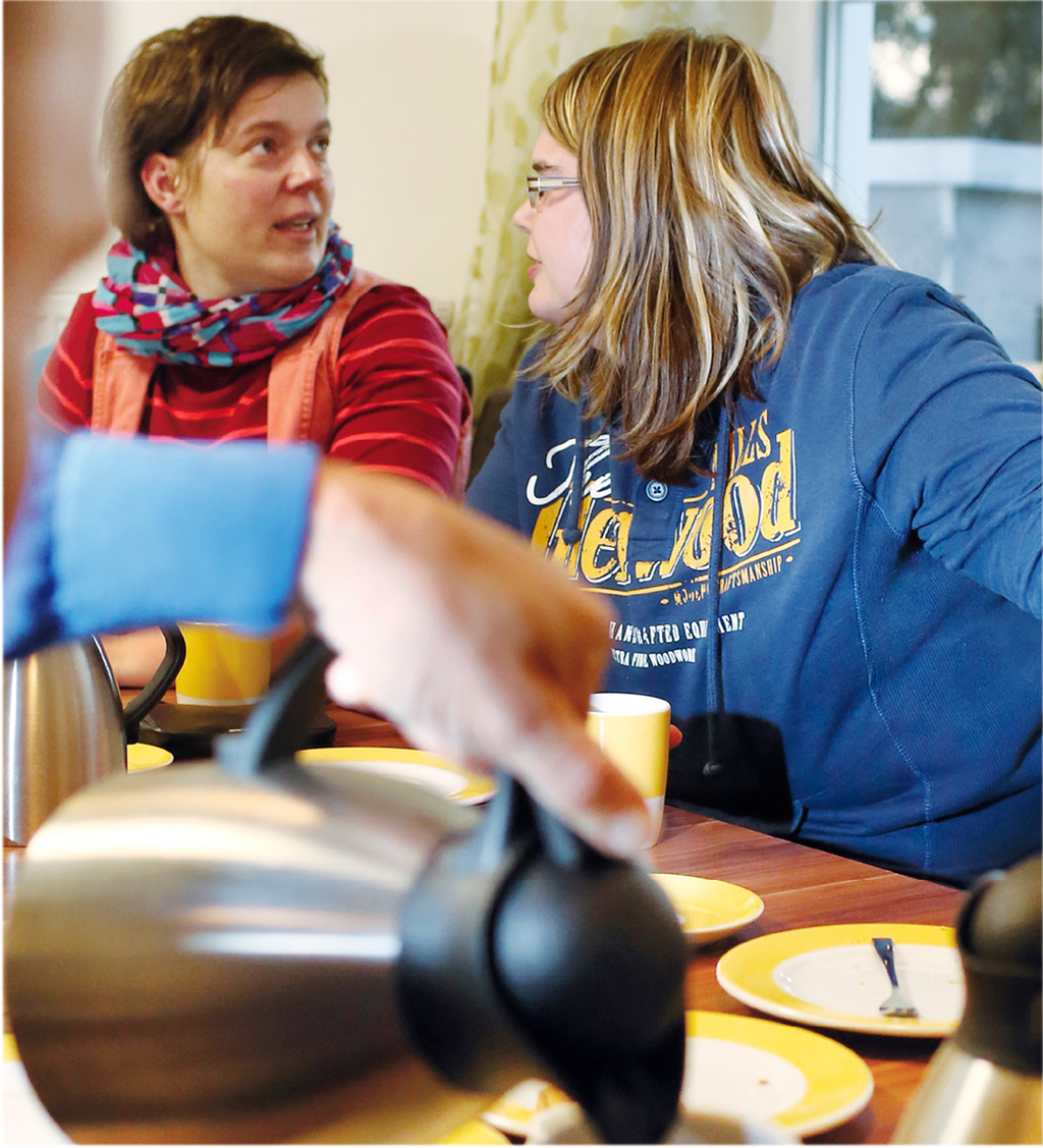 Frauen sitzen an einer Kaffetafel