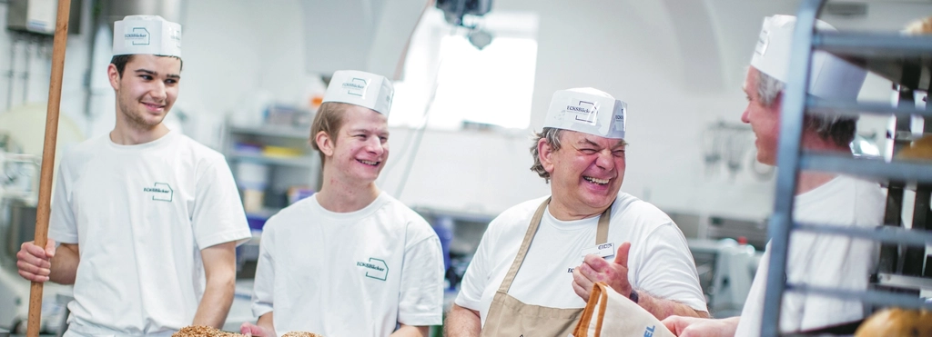 Vier Bäcker arbeiten in einer Backstube