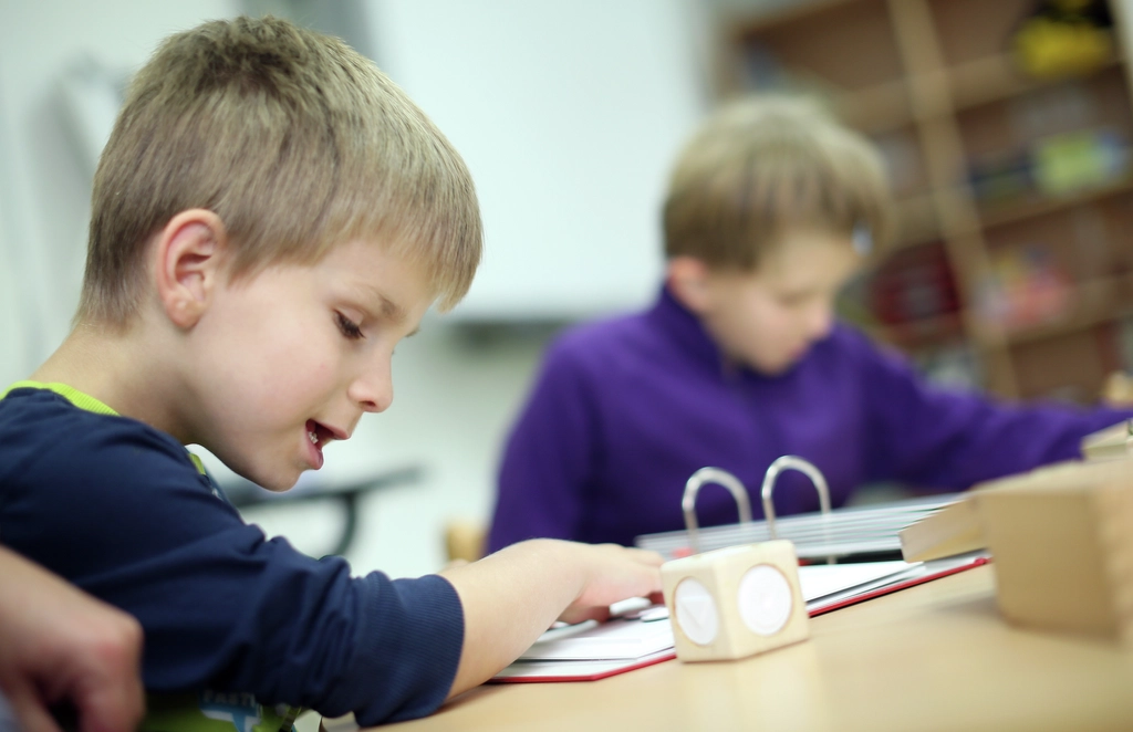 Ein blinder Junge liest Brailleschrift. 