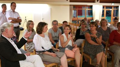 Blick ins Publikum: drei Frauen diskutieren angeregt