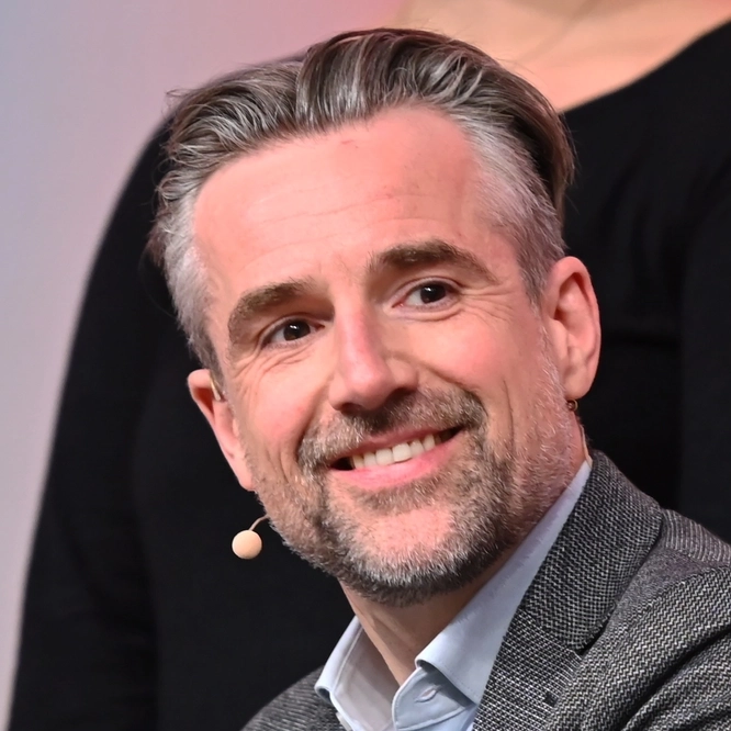 Bild einer Podiumsdiskussion mit Bertolt Meyer, der eine Handprothese trägt.