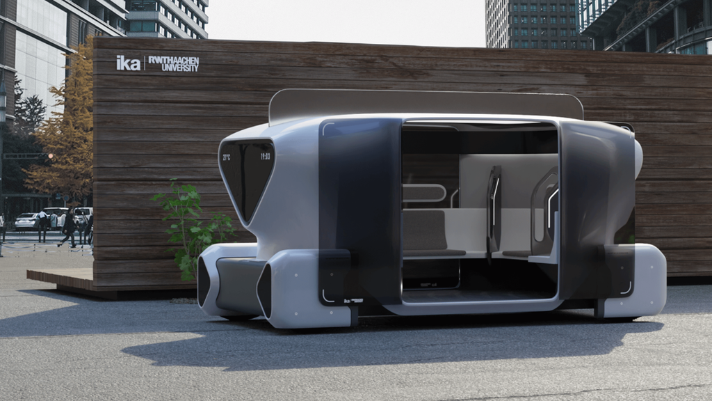 Prototyp eines barrierefreien Fahrzeugs in futuristischer Optik, vor Holzwand mit Ika und RWTH Logos