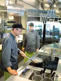 Mitarbeiter beim Fleischbraten in der Restaurantküche